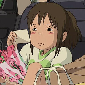 Chihiro from Studio Ghibli's animated movie Spirited Away, looking sadly at a postcard